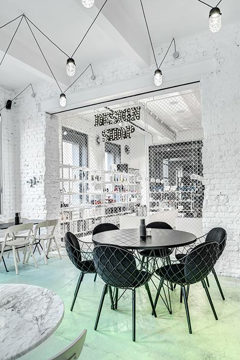 Phill's Corner Bistro Interior Design | mint-green concrete floor & white brick walls